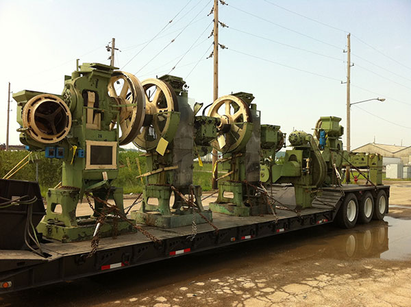 machinery on flatbed trucks